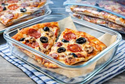 Leftover pizza slices stored in airtight containers and wrapped properly to keep them fresh in the fridge or freezer