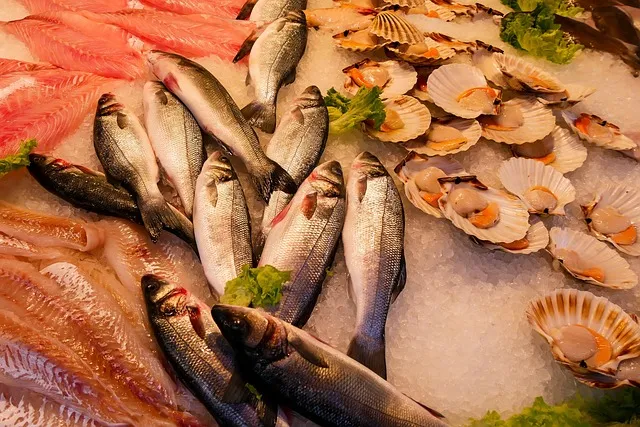 A fresh salmon fillet and shrimp on a bed of ice, demonstrating the best practices for seafood storage.