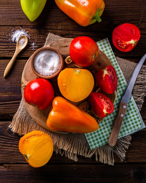 A rustic wooden bowl filled with vibrant red ripe tomatoes.