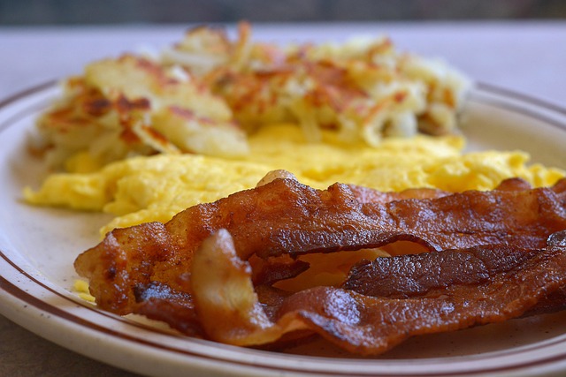 Opened bacon wrapped tightly in plastic wrap and stored in a zip-top bag in the fridge