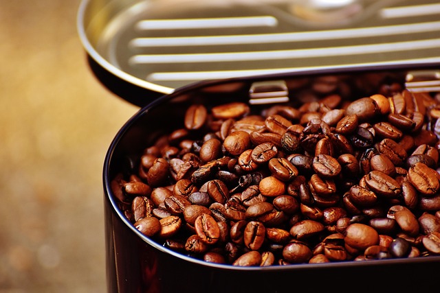 whole coffee beans being poured into an opaque airtight ceramic canister for storage