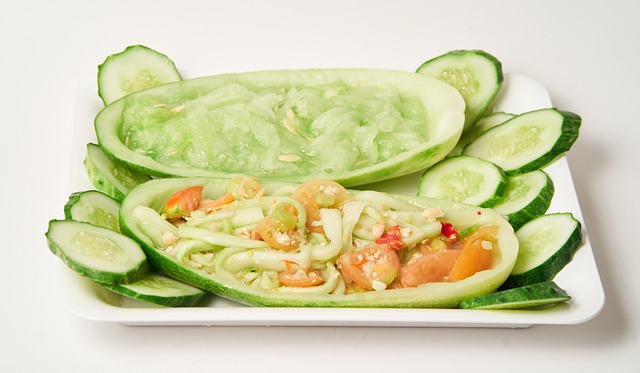 A fresh, crisp cucumber, whole and sliced, ready for proper storage.